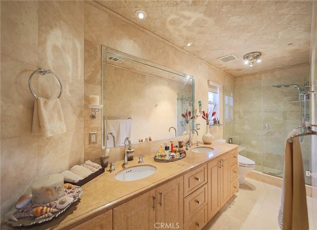 bathroom with vanity, tile patterned floors, toilet, walk in shower, and tile walls