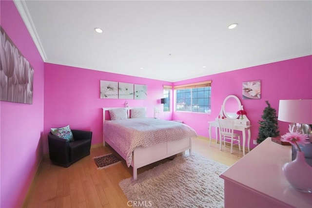 bedroom featuring light hardwood / wood-style floors and crown molding