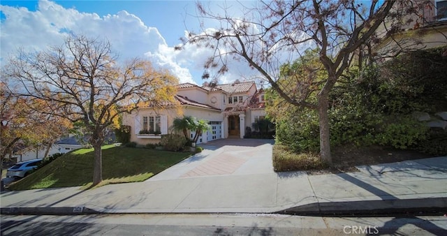 mediterranean / spanish-style home featuring a front yard