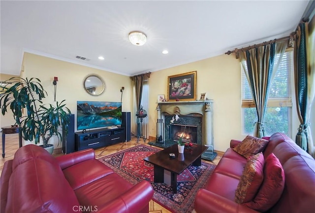 living room with a fireplace, crown molding, and tile patterned flooring