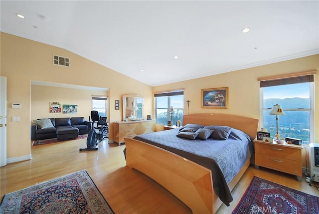 bedroom featuring light hardwood / wood-style floors and lofted ceiling