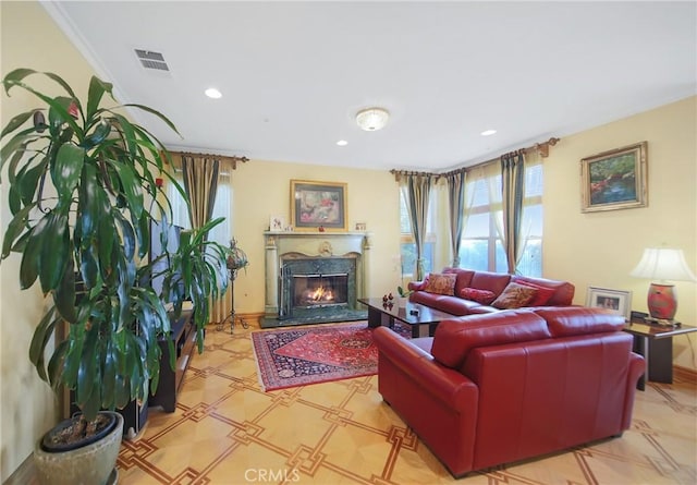 living room featuring ornamental molding and a fireplace