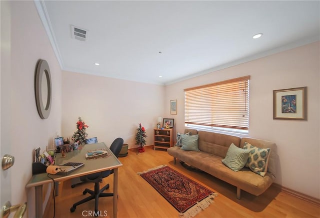 office with light hardwood / wood-style flooring and ornamental molding