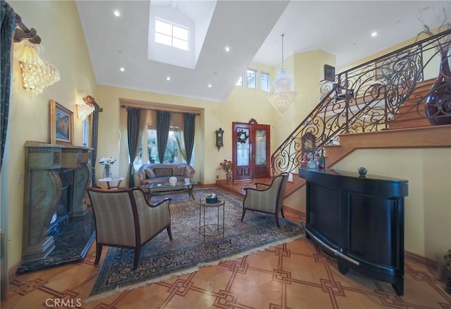 living room featuring an inviting chandelier and high vaulted ceiling