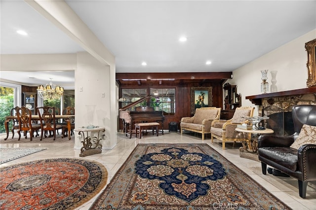 tiled living room with a notable chandelier