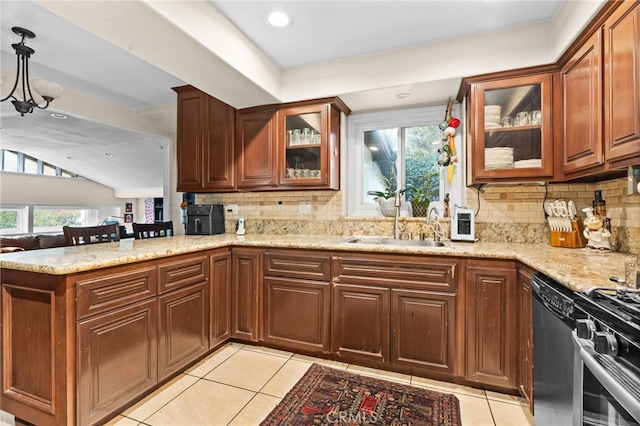 kitchen featuring dishwasher, light tile patterned flooring, kitchen peninsula, and sink