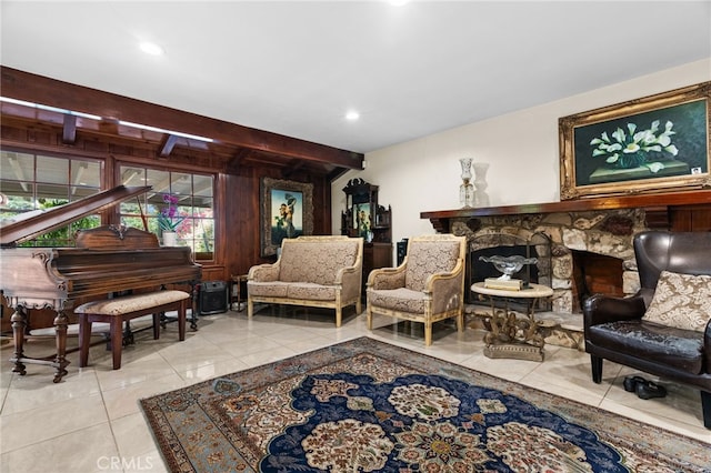 sitting room featuring beamed ceiling and light tile patterned floors