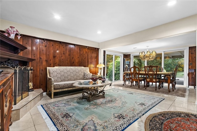 tiled living room with a notable chandelier and wood walls