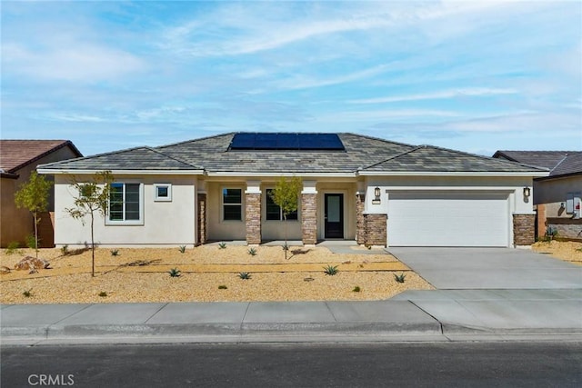 view of front of house featuring solar panels and a garage