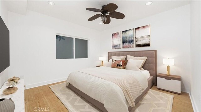 bedroom featuring ceiling fan and light hardwood / wood-style floors