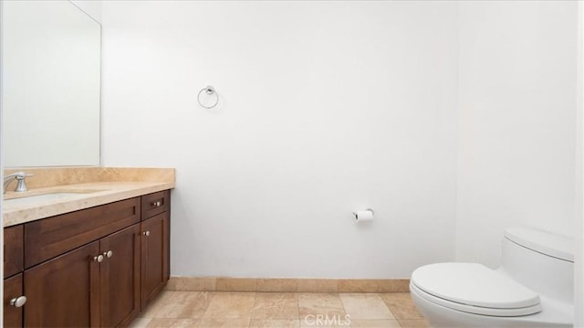 bathroom featuring tile patterned floors, vanity, and toilet