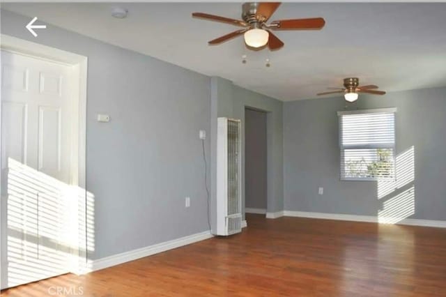 unfurnished room featuring ceiling fan and hardwood / wood-style flooring