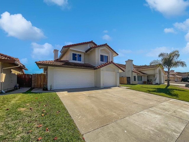 mediterranean / spanish house with a garage and a front lawn