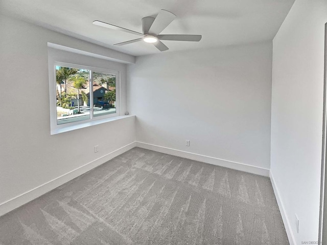 unfurnished room with ceiling fan and carpet floors