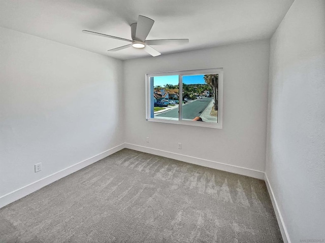 spare room with carpet floors and ceiling fan