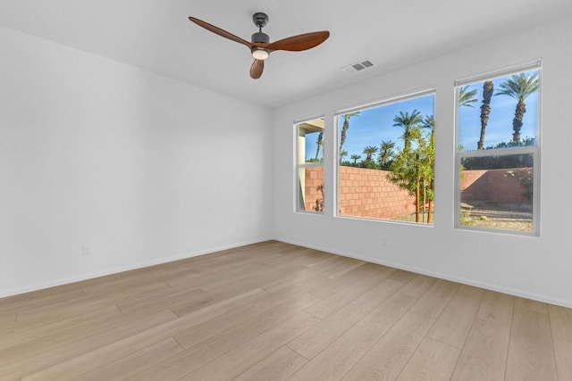 spare room featuring light hardwood / wood-style floors and ceiling fan