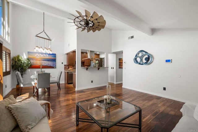 living room with beam ceiling, dark hardwood / wood-style floors, high vaulted ceiling, and ceiling fan