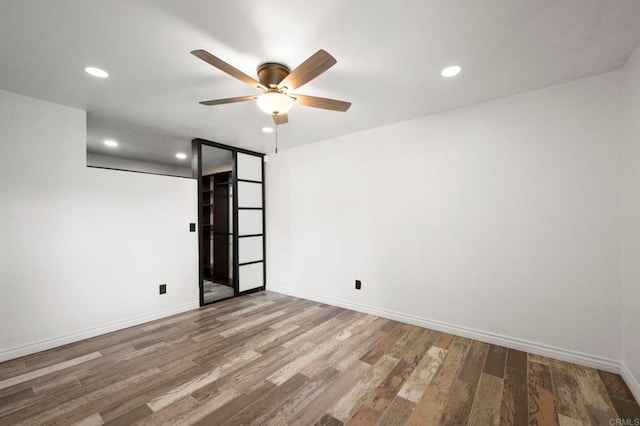 spare room featuring hardwood / wood-style flooring and ceiling fan