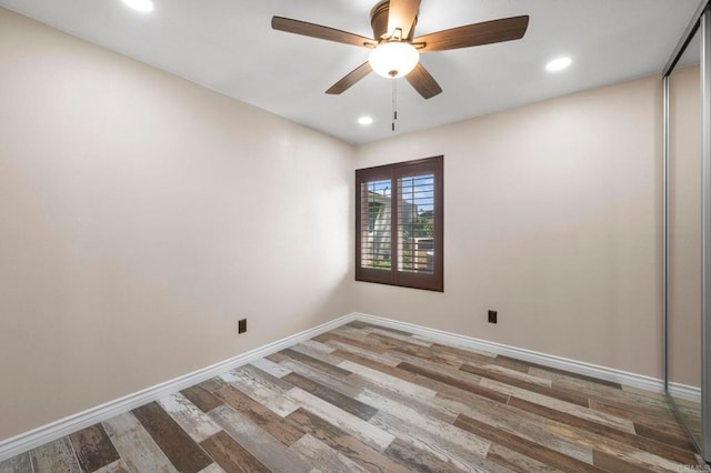 unfurnished room with ceiling fan and hardwood / wood-style floors