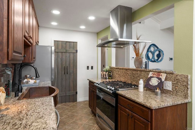 kitchen featuring sink, appliances with stainless steel finishes, tasteful backsplash, island range hood, and light stone counters