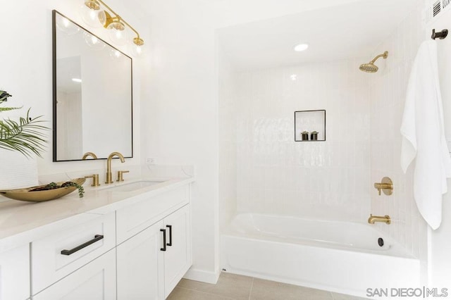 bathroom featuring vanity, tile patterned floors, and tiled shower / bath