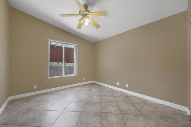 spare room featuring lofted ceiling, light tile patterned floors, and ceiling fan