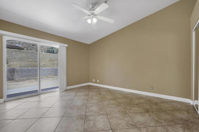 tiled empty room featuring ceiling fan