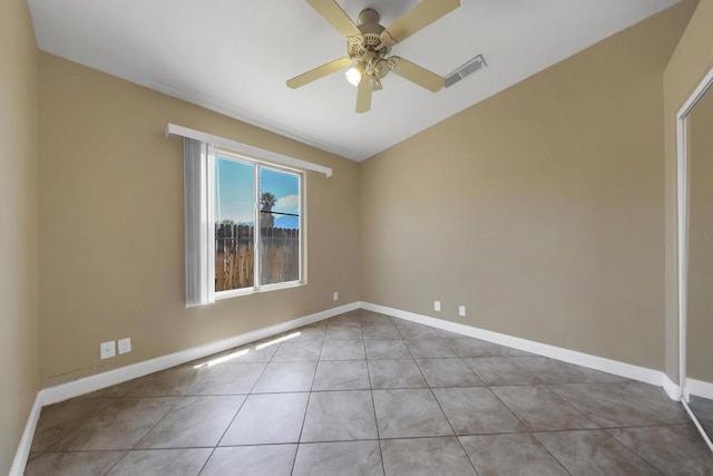 tiled empty room with ceiling fan