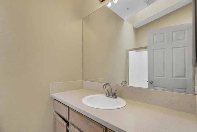 bathroom with lofted ceiling and vanity