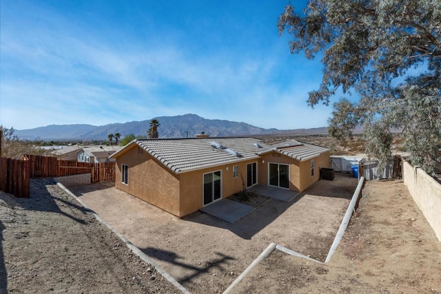 back of property with a mountain view