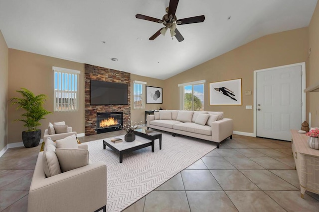 tiled living room featuring ceiling fan, vaulted ceiling, and a fireplace