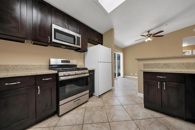 kitchen featuring light tile patterned floors, stainless steel appliances, lofted ceiling, and dark brown cabinetry