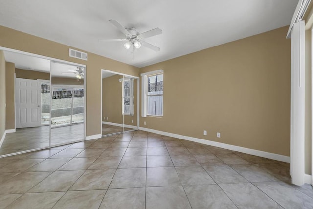 unfurnished bedroom with ceiling fan and light tile patterned flooring