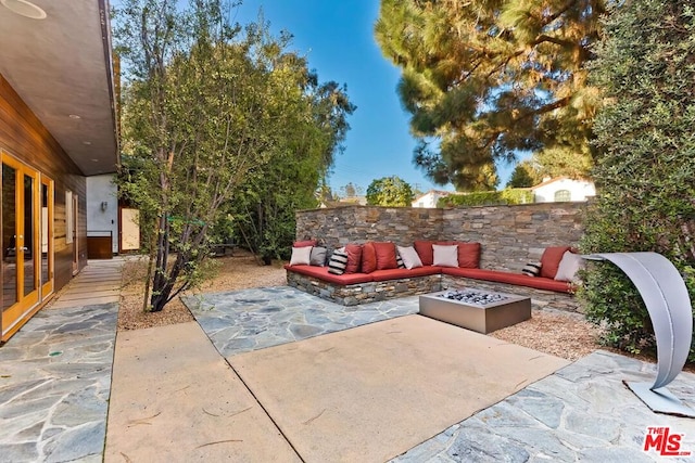 view of patio / terrace with an outdoor living space with a fire pit