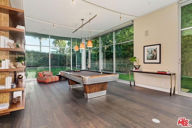 game room featuring billiards, dark wood-type flooring, track lighting, and a wall of windows