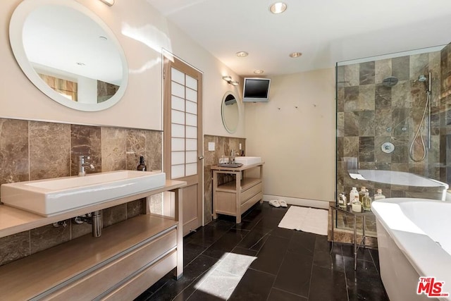 bathroom with tile patterned flooring, vanity, and shower with separate bathtub