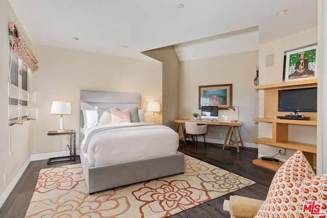 bedroom featuring lofted ceiling and hardwood / wood-style flooring