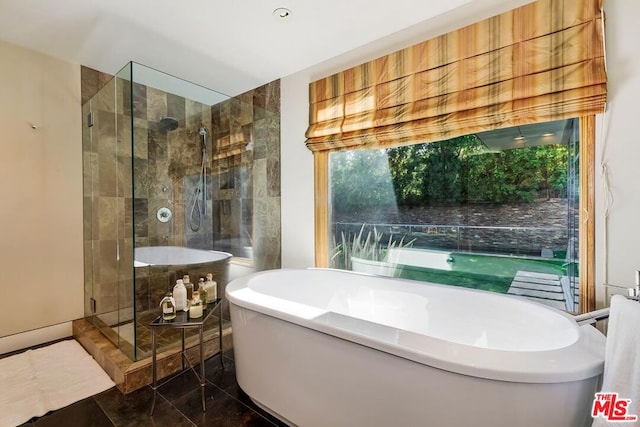 bathroom featuring separate shower and tub