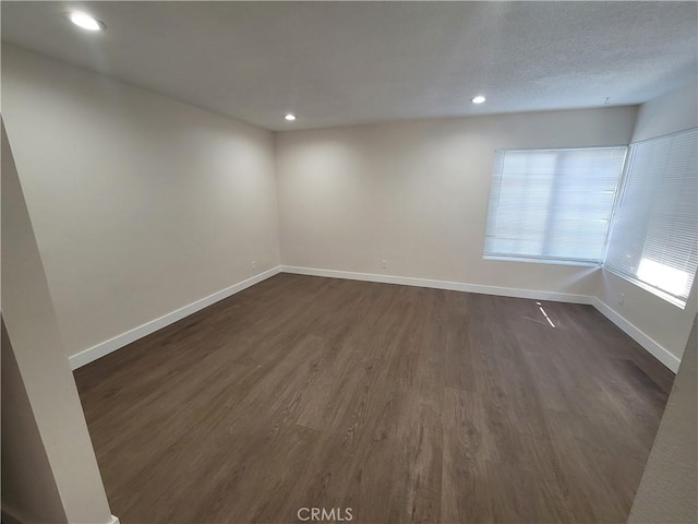 empty room featuring dark hardwood / wood-style flooring