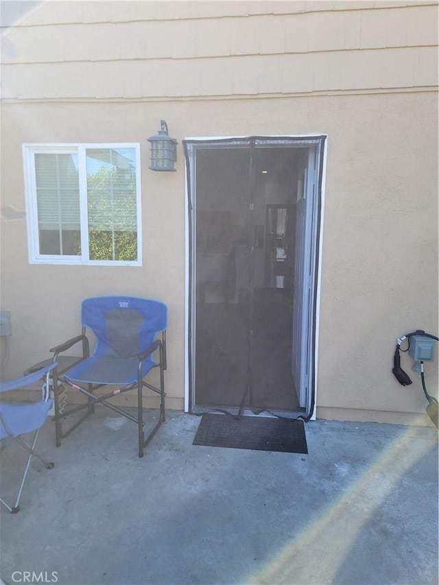 entrance to property with a patio