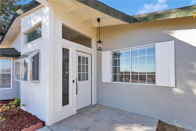 doorway to property with a patio