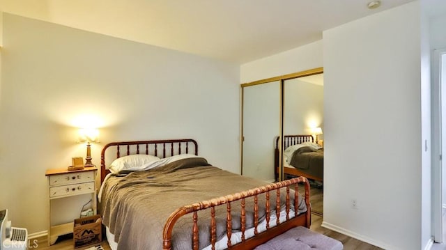 bedroom with hardwood / wood-style floors and a closet