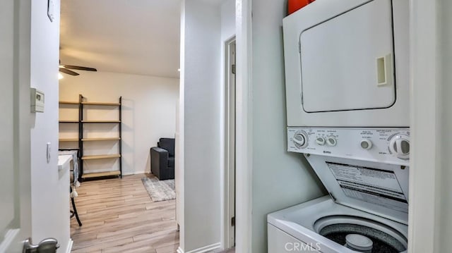 laundry room featuring ceiling fan, stacked washing maching and dryer, and light hardwood / wood-style flooring