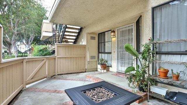 balcony with a patio area and a fire pit