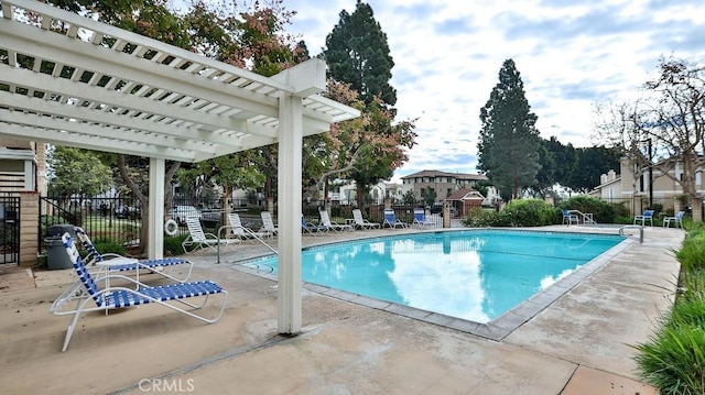 view of pool with a pergola and a patio