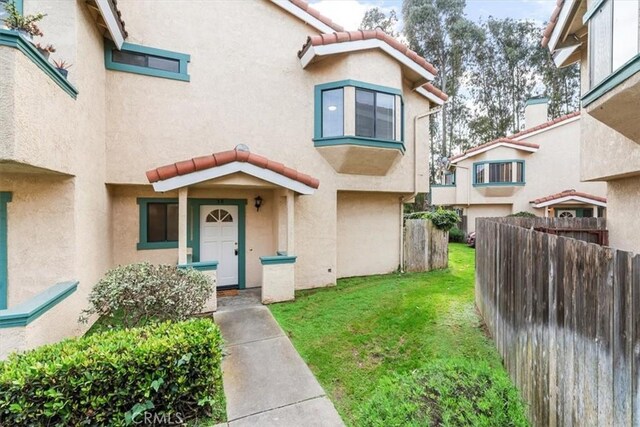 doorway to property with a yard