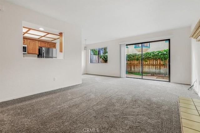 unfurnished living room with light colored carpet