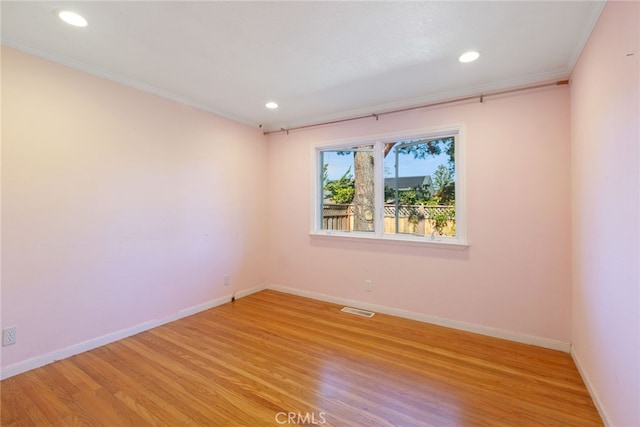 unfurnished room with light hardwood / wood-style floors