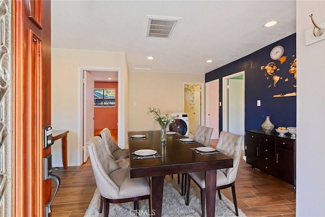 dining room featuring hardwood / wood-style floors and washer / clothes dryer