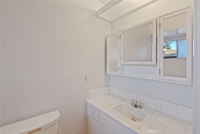 bathroom with tile patterned floors, vanity, and toilet